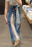 Person wearing blue jeans with sheer panels in a store setting