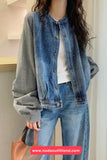 Person wearing a denim jacket and jeans with a blurred background