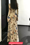 Woman wearing a long floral dress with a blurred background