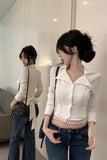 Woman wearing a white blouse and blue jeans in a modern interior setting