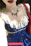 Blue dress with white lace details worn by a person, with a visible brand logo at the bottom.