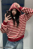 Person wearing a red and white striped hoodie taking a mirror selfie.
