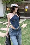 Woman wearing a denim outfit with a colorful cap in an outdoor setting