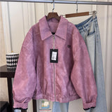 Pink jacket with a tag on a hanger against a neutral background