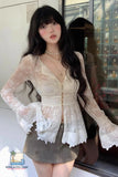 Woman wearing a white lace outfit with a blurred background