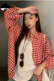 Upgrade your 90s Grunge Aesthetic with this Long Sleeve Classic Red Plaid Blouse Shirt. The ultimate essential for Americana everyday outfits, oversized red checkered flannel trends, and cozy autumn layering lookbooks. Featuring a flattering relaxed drape and a timeless tartan pattern, this versatile top is a must-have for your Button Up Shirts or Vintage Clothing collection.