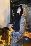 Person wearing a leopard print hoodie in an indoor setting