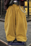 Person wearing mustard yellow corduroy pants with a blurred background