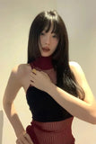 Woman wearing a black top and red pants with a blurred background