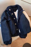 Navy blue jacket with buttons on a chair