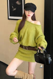 Woman wearing a green off-shoulder sweater and brown knee-high boots indoors.