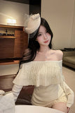 Woman wearing a white off-shoulder top with a decorative headpiece in an indoor setting.
