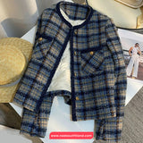 Plaid coat displayed on a mannequin with a blurred background
