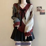 Person wearing a patterned sweater and black skirt against a plain background