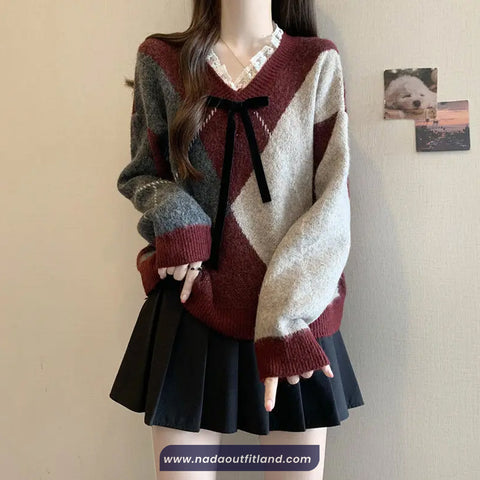 Person wearing a patterned sweater and black skirt against a plain background