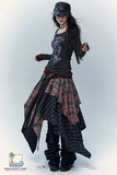 Person wearing a unique outfit with a plaid skirt and dark top on a white background