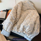 Floral-patterned jacket on a chair with a book underneath