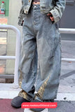 Person wearing oversized blue jeans with camouflage accents on a city street.