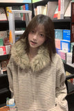 Woman in a striped coat with fur collar in a bookstore
