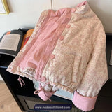 Floral-patterned jacket with pink accents on a black surface