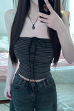 Person wearing a black striped top and jeans, taking a mirror selfie.