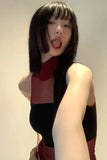 Person wearing a black and red sleeveless top with a plain background