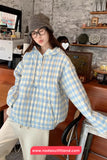 Person wearing a blue and white checkered hoodie in a casual setting