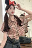 Person wearing a plaid shirt and denim pants with a decorative headband.