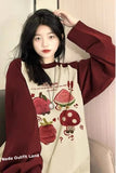 Person wearing a maroon and cream outfit with cartoon designs