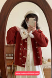 Person wearing a red cardigan over a white dress, taking a mirror selfie.