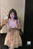 Woman in a layered dress taking a mirror selfie.