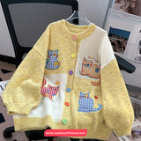 Yellow cardigan with cat patches on a chair