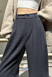 Person wearing plaid pants with a blurred background