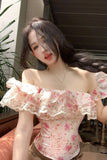 Woman wearing a floral off-shoulder top outdoors