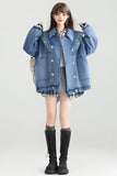 Person wearing a blue denim jacket with decorative buttons on a white background
