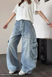 Person wearing a white t-shirt and blue cargo pants in an indoor setting.