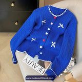 Blue sweater with decorative buttons on a chair