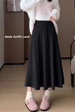 Person wearing a black pleated skirt and white sweater with 'Nada Outfit Land' branding.