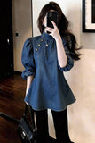 Person wearing a blue denim dress taking a mirror selfie.