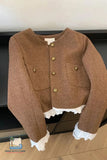 Brown jacket with lace trim on a wooden floor