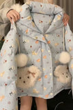 Light blue jacket with teddy bear patterns and pom-poms held by a person.