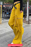 Person wearing bright yellow cargo pants on a city street.