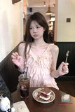 Woman sitting at a table with a drink and cake in a cafe