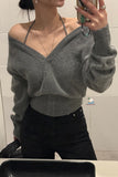 Person wearing a gray off-shoulder sweater taking a mirror selfie.