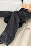 Person wearing black pants sitting on a white surface with a brand logo in the corner.