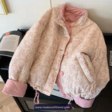 Floral patterned jacket with pink trim on a surface