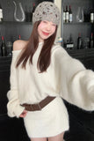 Woman wearing a white sweater and gray knit hat in a bar setting