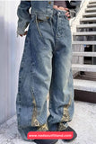 Person wearing oversized blue jeans with camouflage patches on a staircase.