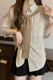 Woman wearing a striped shirt with a brown bow tie and black skirt indoors.