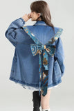 Denim jacket with a decorative back panel on a white background